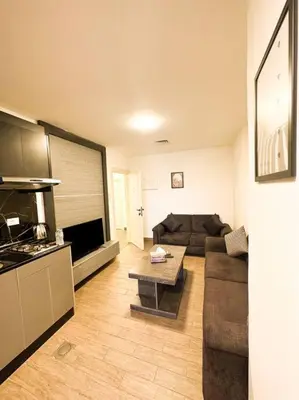 a living room with a couch and a table at central apartment for rent 26 in Umm Uthainah
