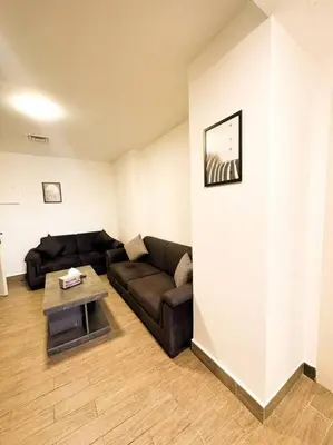 a living room with a couch and a table at central apartment for rent 26 in Umm Uthainah