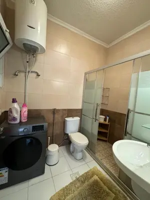 a bathroom with a toilet and a sink and a microwave at Modern chic haven in Amman