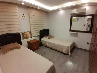 a hotel room with two beds and a mirror at MK3 - Two Bedroom Apartment in Amman