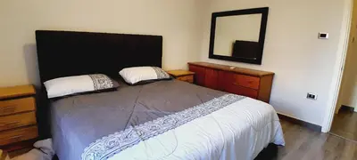 a bedroom with a large bed and a mirror at MK3 - Two Bedroom Apartment in Amman