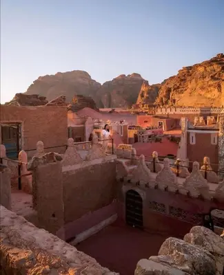a view of a village with mountains in the background at Golden sunset luxury camp in Wadi Rum