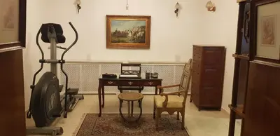 a room with a desk and a chair and a picture on the wall at Charming Apartment in Shmeisani in Amman