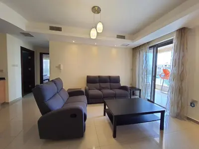 a living room with a couch and a coffee table at Abdoun Panorama in Amman