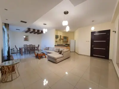 a living room with a couch and a table at Abdoun Panorama in Amman