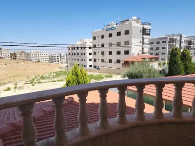 a balcony with a view of a city at Shafa Badran Families Apt in Amman