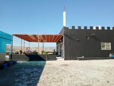 a building with awning on the side of it at shalyh tal birin in Şarrūt