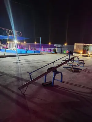 a row of benches in a parking lot at night at shalyh tal birin in Şarrūt