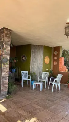 a patio with two chairs and a table and a table and chairs at Simple home in Madaba