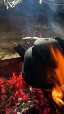 a pot on top of a camp fire at Simple home in Madaba