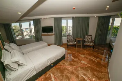 a bedroom with a bed and a table and chairs at Yafko Hotel in Aqaba