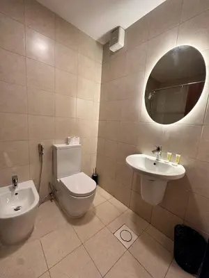 a bathroom with a toilet and a sink and a mirror at Alraha VIP Marsa zayed Aqaba in Aqaba