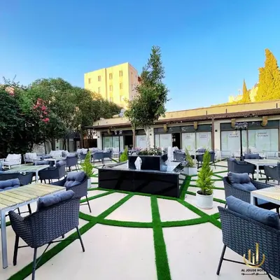 a patio with tables and chairs in a courtyard at Al Joude Hotel فندق الجود in Irbid