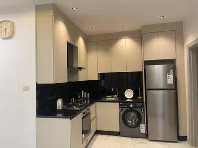 a kitchen with a stainless steel refrigerator and a dishwasher at Oqdeh Delux Apartments in Jerash