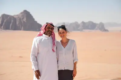 a man and a woman standing on the beach at Desert's Soul Wadi Rum in Disah