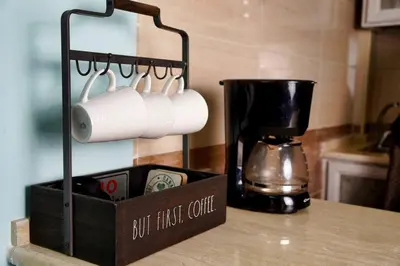 a box of coffee cups on a counter next to a coffee maker at Treasure of Petra in Wadi Musa
