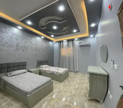 a bedroom with two beds and a ceiling at Treasure of Petra in Wadi Musa