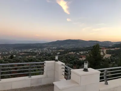 a view of a city from the balcony of a house at The Pine Tree Chalet in Jerash