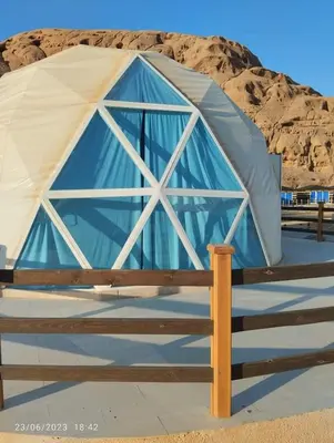 a blue and white tent with a wooden fence at Sami Al Muzna Rum Camp in Wadi Rum