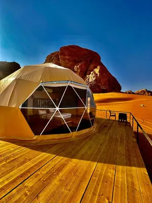 a tent on a wooden deck in the desert at Mirage Camp Wadi Rum in Wadi Rum