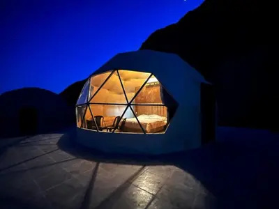 a blue room with a tent with a window at Wadi Rum Spring Moon & Jeep Tour in Wadi Rum