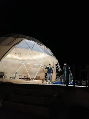 two people standing in a tent at night at Sun Luxury Rum Camp in Wadi Rum