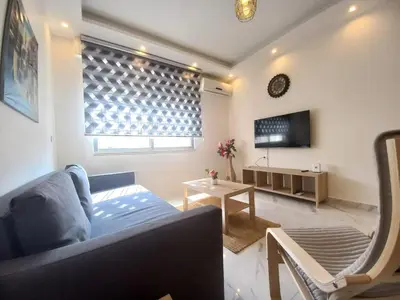 a living room with a couch and a table at Shmeisani homes central location near Abdali in Amman