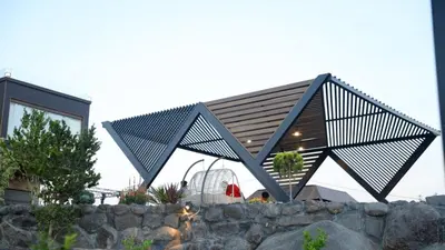 a house with a metal roof on top of a stone wall at Kinda vip in Al Mashāriqah