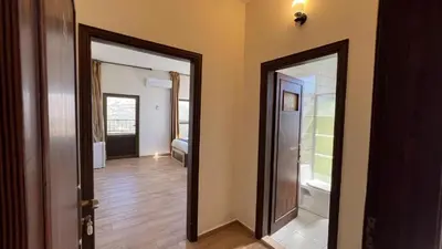 a hallway with two doors to a room with a bathroom at Al-jabal castle Hotel - Ajloun in Ajloun