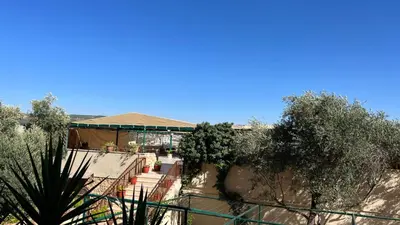 a view of a building with trees in the foreground at Al-jabal castle Hotel - Ajloun in Ajloun