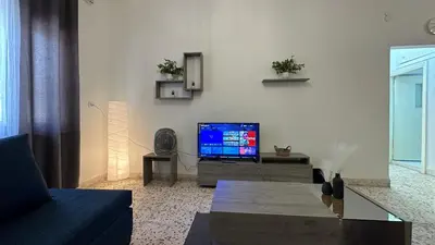 a living room with a flat screen tv on a wall at Turkuaz Aparment in Amman