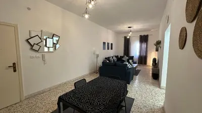 a living room with a couch and a table at Turkuaz Aparment in Amman