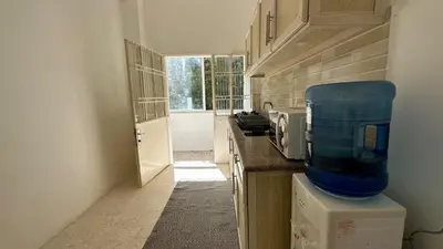 a kitchen with a counter with a microwave on top at Turkuaz Aparment in Amman