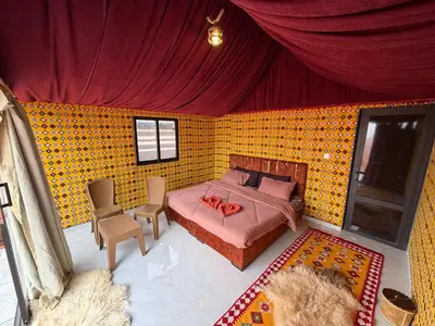 an overhead view of a bedroom with a bed and chairs at Bedouin Nature Camp in Wadi Rum