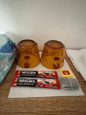 two jars of honey and a magazine on a table at بيت جرش - Jerash House in Jerash