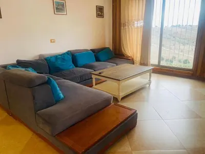 a living room with a couch and a coffee table at North Jewel 2023 in Ajloun