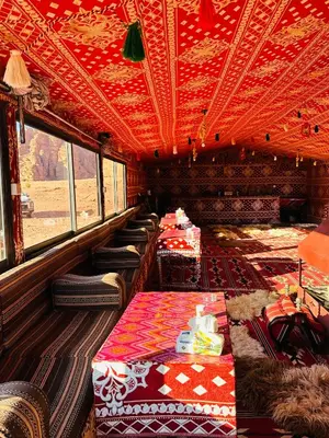 a room with tables and chairs in a bus at Milk way desert in Wadi Rum