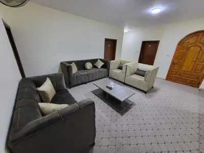 a living room with couches and a coffee table at Petra Hills House in Wadi Musa