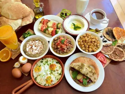 a table topped with plates of breakfast foods and drinks at Petra Hills House in Wadi Musa