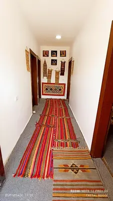 a hallway with a colorful rug on the floor at Petra Magic Guest House in Wadi Musa