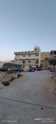 a parking lot in front of a building at Petra Magic Guest House in Wadi Musa