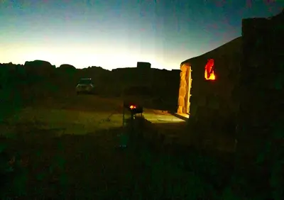 a car parked in a parking lot at sunset at Pink city cottage in Wadi Musa
