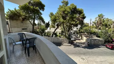 a balcony with two chairs and a table at The vintage apartment in Amman
