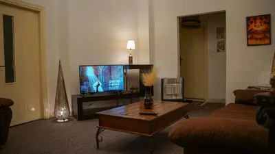 a living room with a television and a coffee table at The vintage apartment in Amman