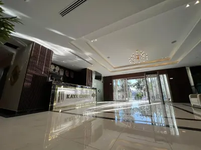 a lobby with a glass floor and a chandelier at Kaya Hotel Amman in Amman