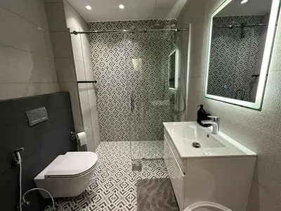 a bathroom with a sink and a toilet and a mirror at Damac Tower Amman Luxury Apartments - استوديوهات وشقق فاخرة - داماك عمان العبدلي in Amman