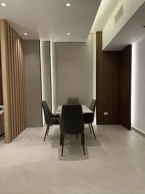 a dining room with a table and black chairs at Damac Tower Amman Luxury Apartments - استوديوهات وشقق فاخرة - داماك عمان العبدلي in Amman