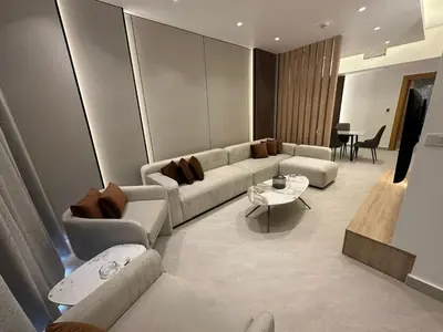 a living room with a couch and a table at Damac Tower Amman Luxury Apartments - استوديوهات وشقق فاخرة - داماك عمان العبدلي in Amman
