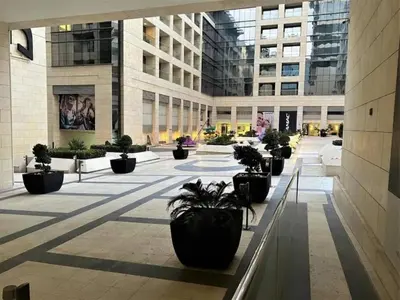 a hallway with potted plants in a building at Damac Tower Amman Luxury Apartments - استوديوهات وشقق فاخرة - داماك عمان العبدلي in Amman