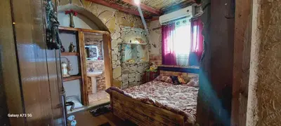 a small bedroom with a bed in a stone room at My Grandfathers House Dana Heritage and Eco Lodge in Dana